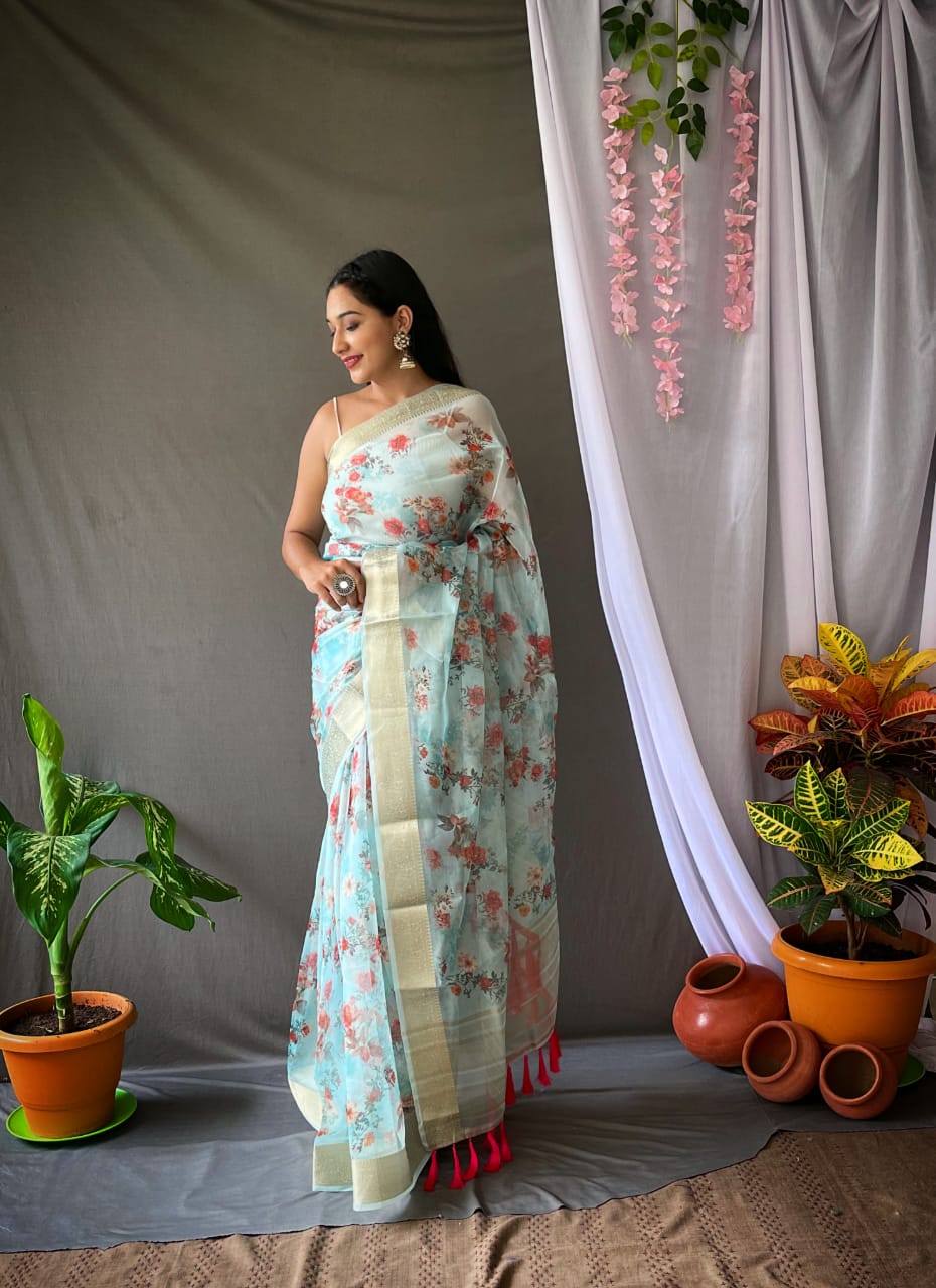 Light Blue Organza Floral Printed Sarees With Elegant Zari Weaving Rich Pallu And Jacquard Weaving Border Paired With Printed Banglori Silk Blouse